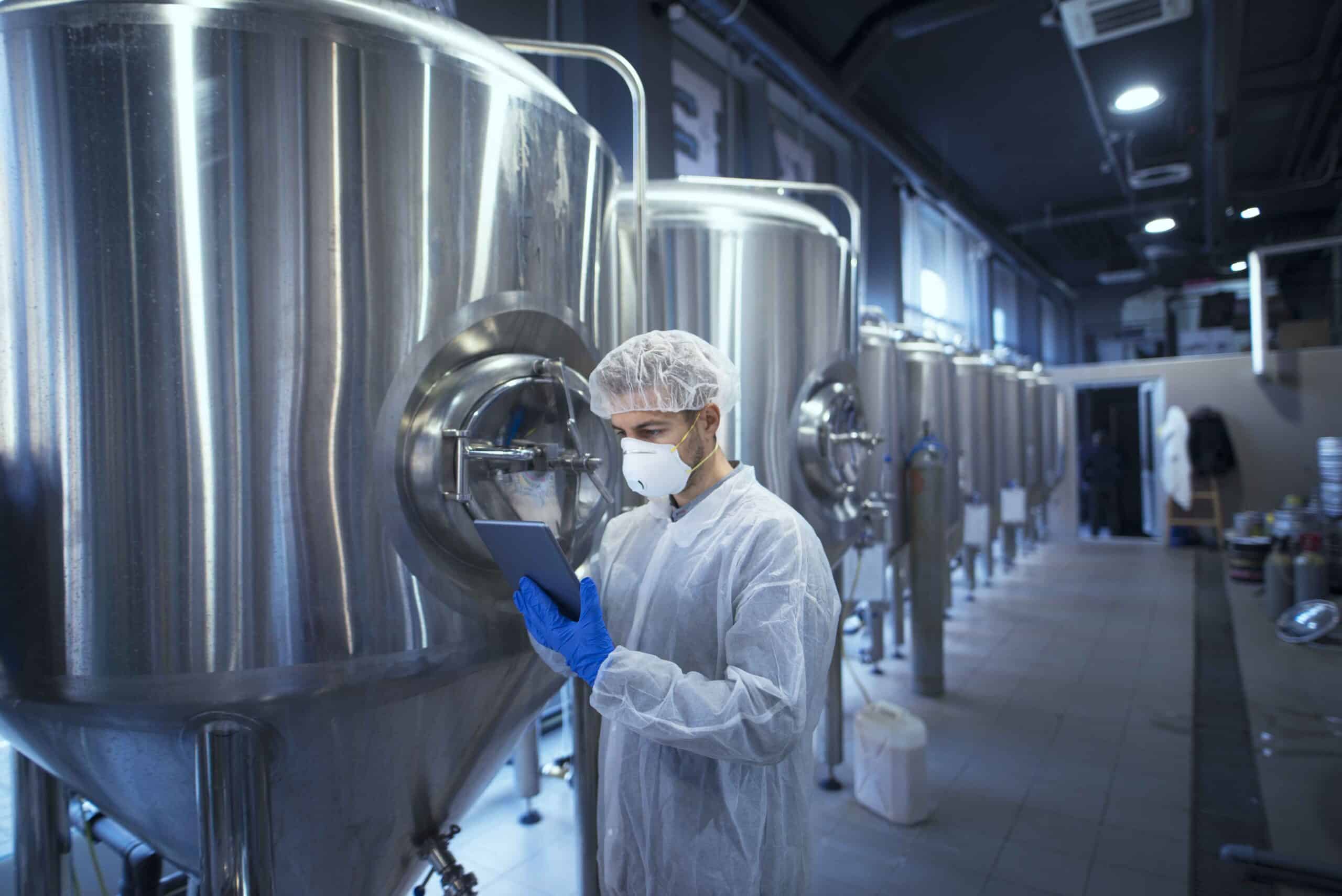 Factory worker technologist in protective uniform with hairnet a